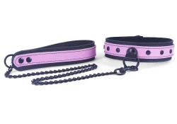 double strap leash and collar 1.25" wide, 3/4 top style. Rose leather top, black leather bottom. On collar: large black d ring with clamp, black dots. On leash: black hardware and black chain 0.25" thick.