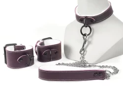 Single strap collar and leash 1" wide, and cuffs 2" wide. Chocolate raspberry leather, white fur inner lining, On cuffs black d ring in center, on collar: black loop & dee, on leash: silver chain 0.25" thick.