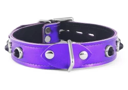 Single strap collar 1" wide. Purple metallic leather, black suede inner lining, silver triangle in center, onyx dome gems.