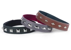 Examples of 1" collars with snap closures and different studs. Left: forest green leather, black lambskin lining, pyramids. Center: grey leather, fuchsia lambskin lining, waves. Right: milk chocolate leather, teal lambskin, diamond dots.