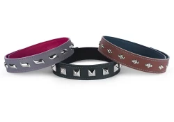 Examples of 1" collars with snap closures and different studs. Left: grey leather, fuchsia lambskin lining, waves. Center: forest green leather, black lambskin lining, pyramids. Right: milk chocolate leather, teal lambskin, diamond dots.