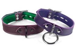 Two 1" wide collars. Left: Chocolate raspberry leather, italian green fur inner lining, black d ring, silver locking buckle. Right: Midnight Purple leather, purple lambskin inner lining, silver loop & dee, silver locking buckle.