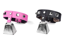 Two single strap collars 1" wide with cowbells. Left: pink leather, large dots. Right: black leather, baby leopard fur inner lining, pyramids