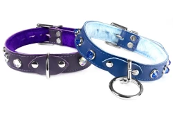 Two 1" collars. Left: Midnight Purple leather, purple fur inner lining, d ring in center, opal gems. Right: royal blue leather, baby blue fur inner lining, silver loop & dee, sapphire gems