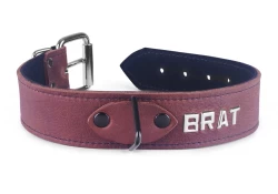 Single strap collar 1.25" wide. Mahogany leather (discontinued), black suede inner lining, black triangle in center, lettering.