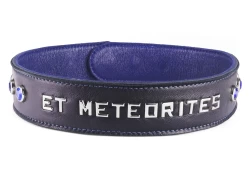 1.5" wide single strap collar. Black lambskin outer layer, royal blue lambskin inner lining, lettering, sapphire gems on the sides, snaps closure (on the back).
