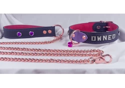 1" wide collar and leash. Black leather, red suede inner lining, rose-gold hardware, lettering and amethyst gems. On the collar iris leather touch and small purple jingle bell on the centered D ring.