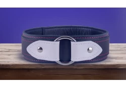 1.75" wide collar with wings. Top strap is 1.25" wide. Black leather top strap (with white leather wings), black leather bottom strap with black leather inner lining. 1.5" o-ring in center.