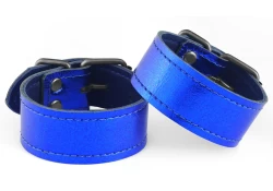 Single strap cuffs, 1" wide. Metallic blue leather, royal blue lambskin inner lining, nickel-free buckle.